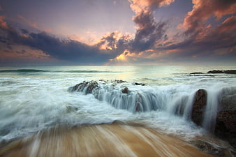 Dramatic Long Exposure Seascape with Cascading Waves and Sunset