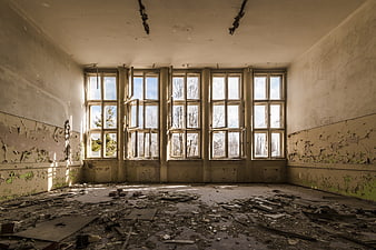 Abandoned dilapidated room with peeling paint and debris