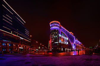 Vibrant Moscow Cityscape at Night with Neon Lights and Snow