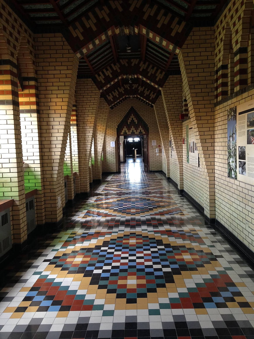 Colorful tiled floor in a historic brick cloister hallway