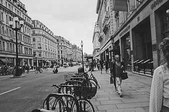 Black and white street scene in London with bicycles and pedestrians