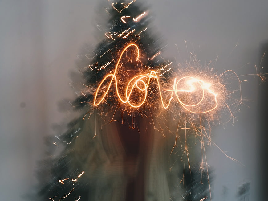 Sparkler writing love on Christmas tree long exposure