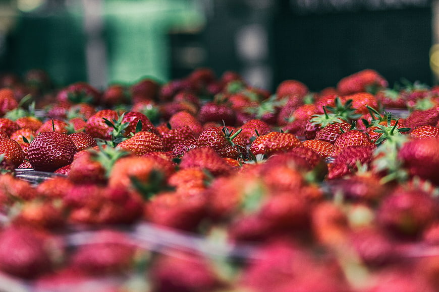 Fresh Red Strawberries in Plastic Containers at Market