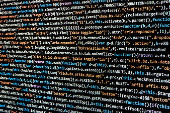 Close-up of colorful programming code on a dark computer screen