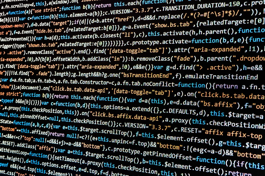 Close-up of colorful programming code on a dark computer screen