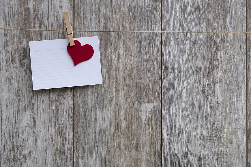 Red felt heart on note card hanging on clothesline
