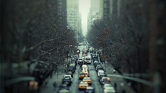 Tilt-shift city street with yellow taxis and traffic