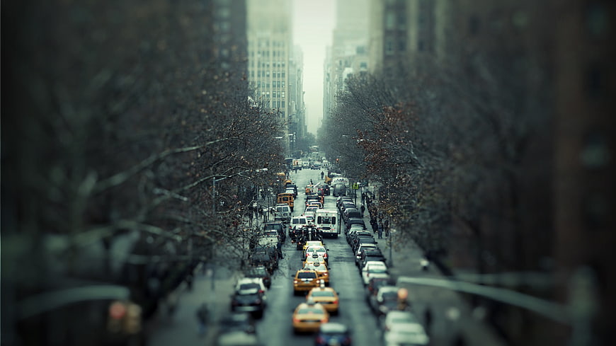 Tilt-shift city street with yellow taxis and traffic