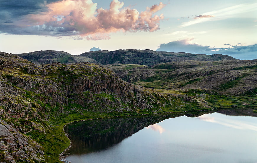 Scenic Mountain Lake with Rocky Hills and Cloudy Sky