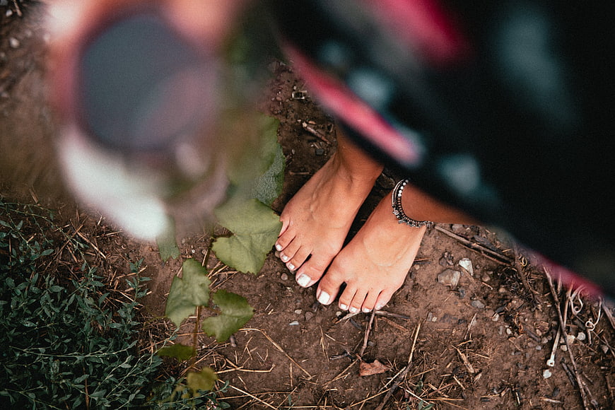 Barefoot Woman Standing on Earthy Ground with Anklet