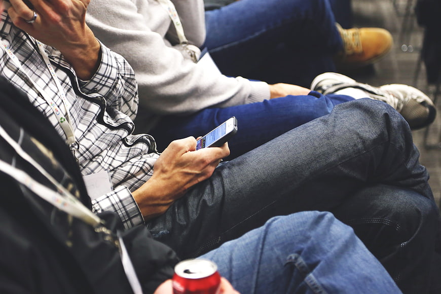 Close-up of person using smartphone at conference