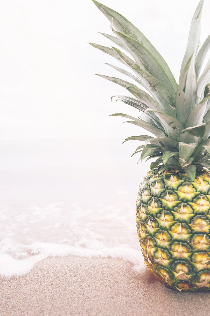 Fresh Pineapple on Sandy Beach with Ocean Waves