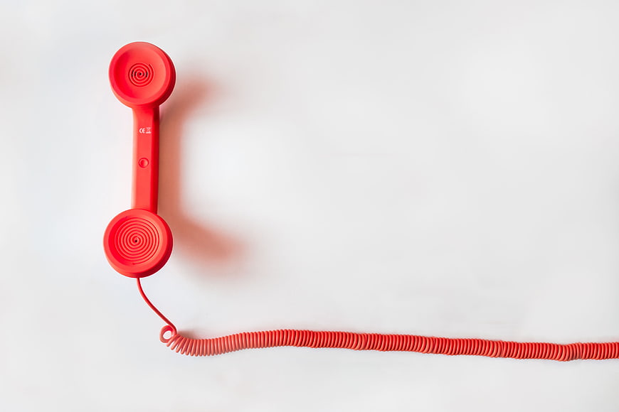 Red Corded Telephone Handset on White Background