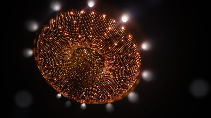Abstract golden spiral structure with glowing lights on black background