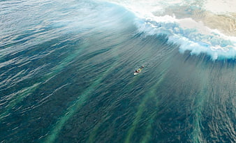 Aerial View of Surfer Riding a Massive Ocean Wave