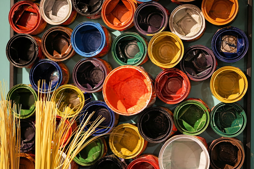 Top View of Multicolored Paint Cans and Brushes