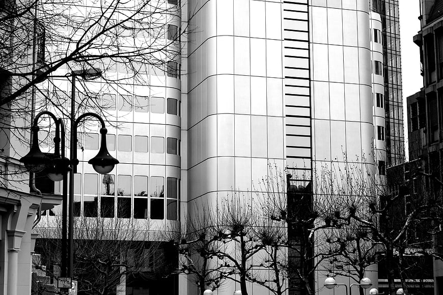 Black and white modern office building with bare trees
