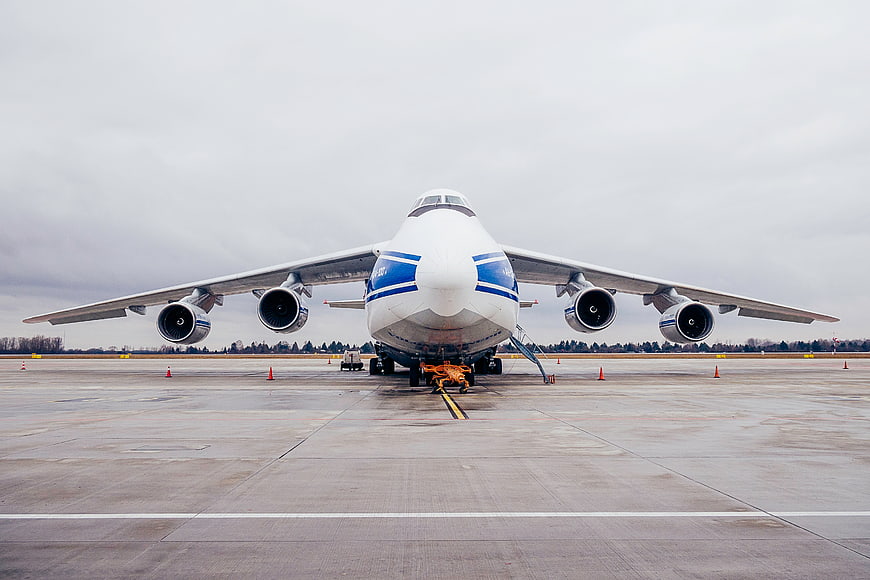 Front view of large cargo airplane on airport tarmac