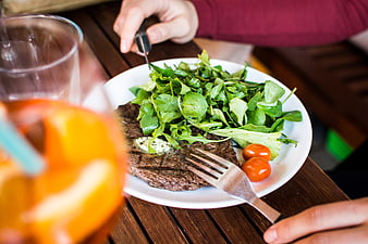 Grilled steak with fresh salad on wooden table