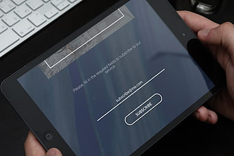 Hands holding tablet with email subscription form interface