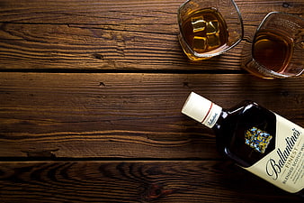 Ballantine's Scotch Whisky Bottle and Glasses on Wood