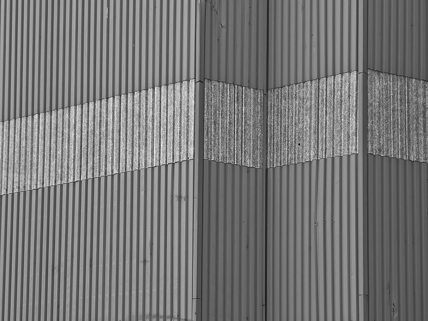 Abstract black and white corrugated metal wall texture