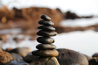 Balanced Stack of Smooth River Stones on Rocky Shore