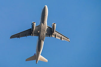 Low Angle View of White Airplane Flying in Blue Sky