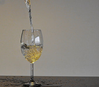 Pouring White Wine into Glass with Splash