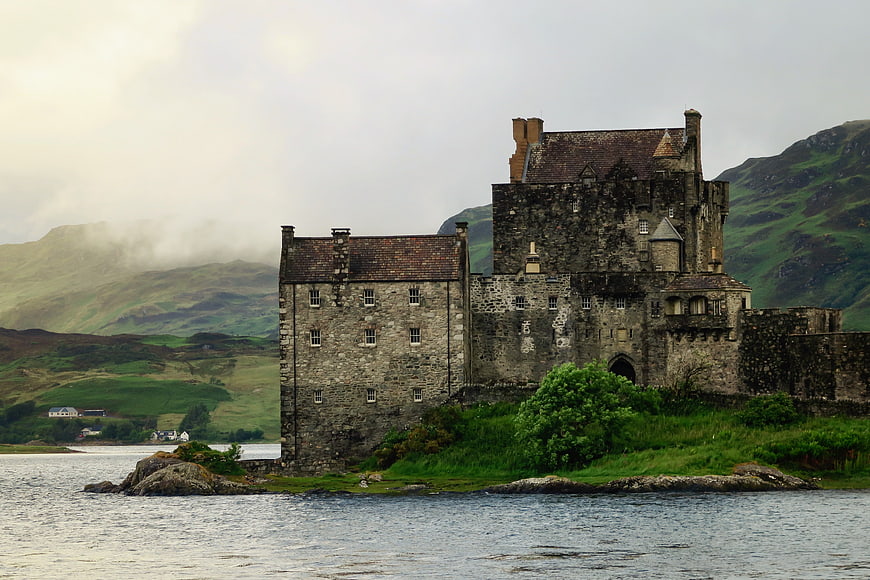Historic stone castle on a rocky island in a Scottish loch