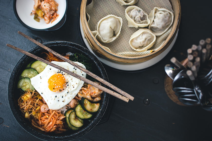 Top View of Korean Bibimbap and Steamed Dumplings