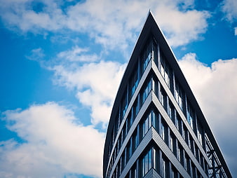 Low Angle View of Modern Office Building Against Blue Sky
