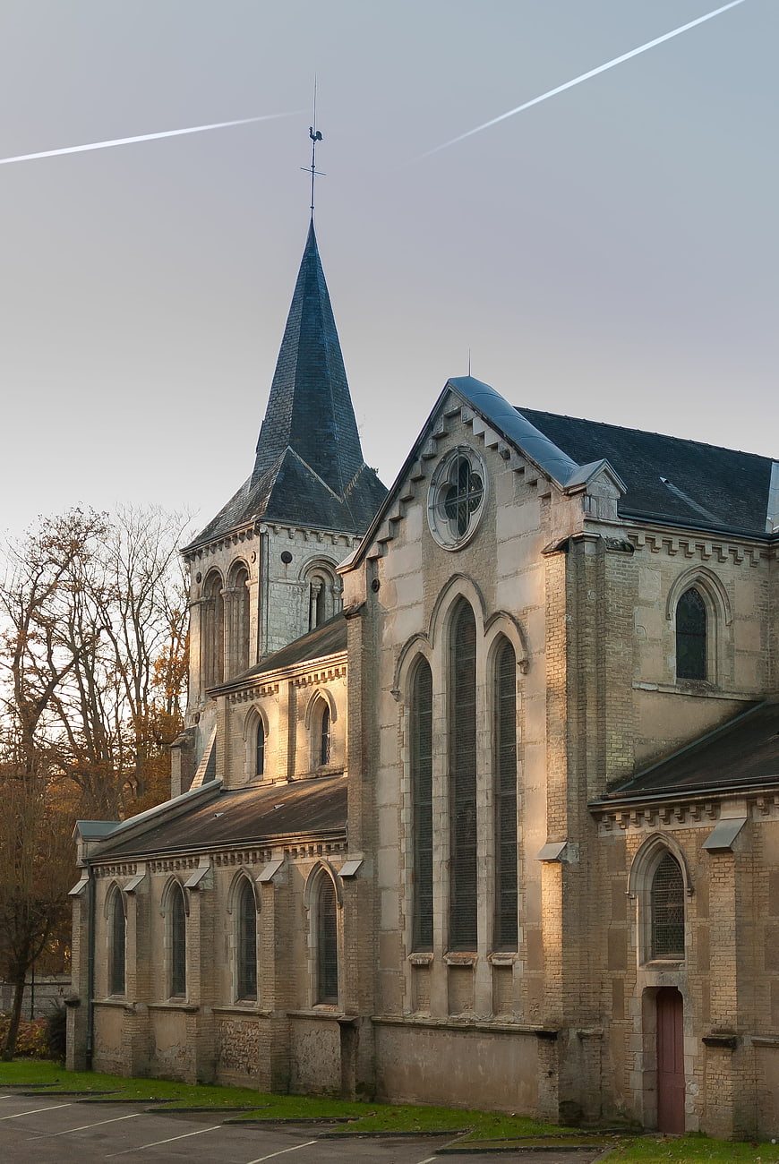 Sunlit Gothic Church with Spire and Contrails