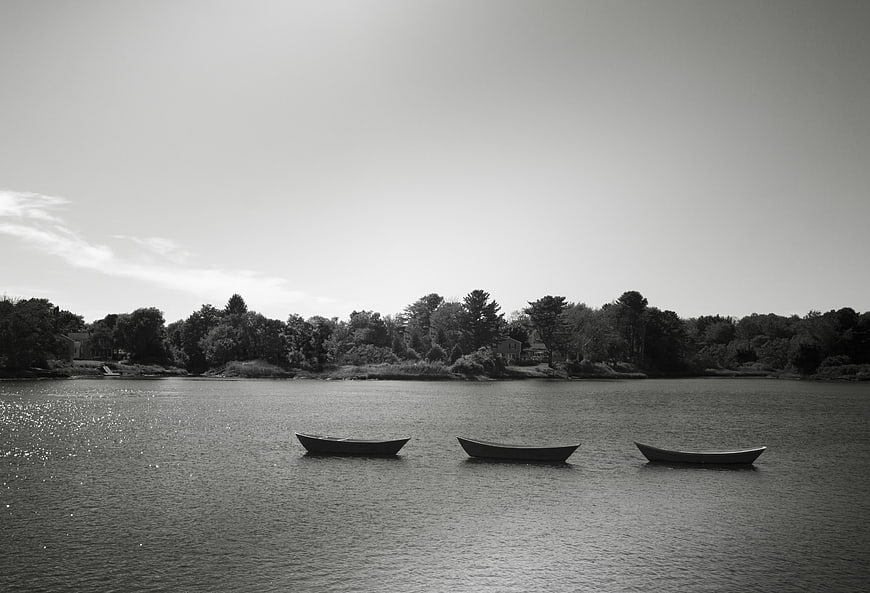 Three Rowboats Floating on a Calm Black and White Lake