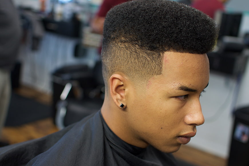 Young man with high fade afro haircut in barbershop