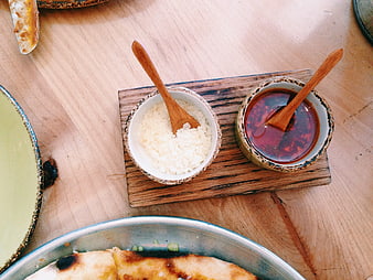 Top view of dipping sauces and cheese on wooden board