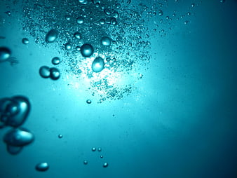 Underwater Bubbles Rising in Blue Water