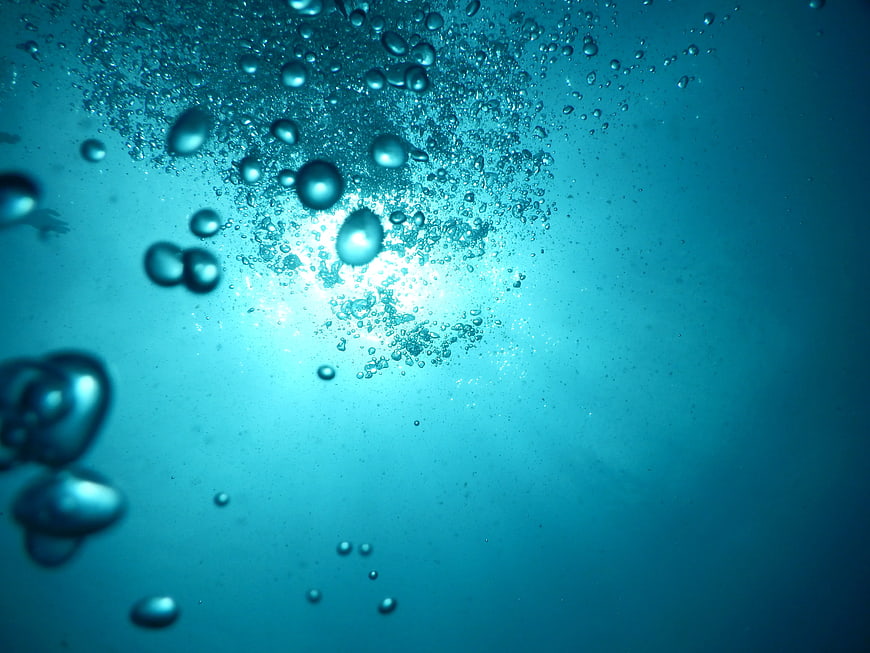 Underwater Bubbles Rising in Blue Water