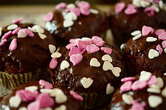 Chocolate muffins with pink and white heart sprinkles