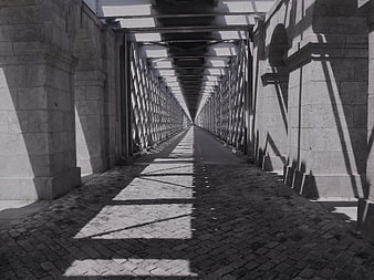 Black and white perspective of cobblestone bridge walkway