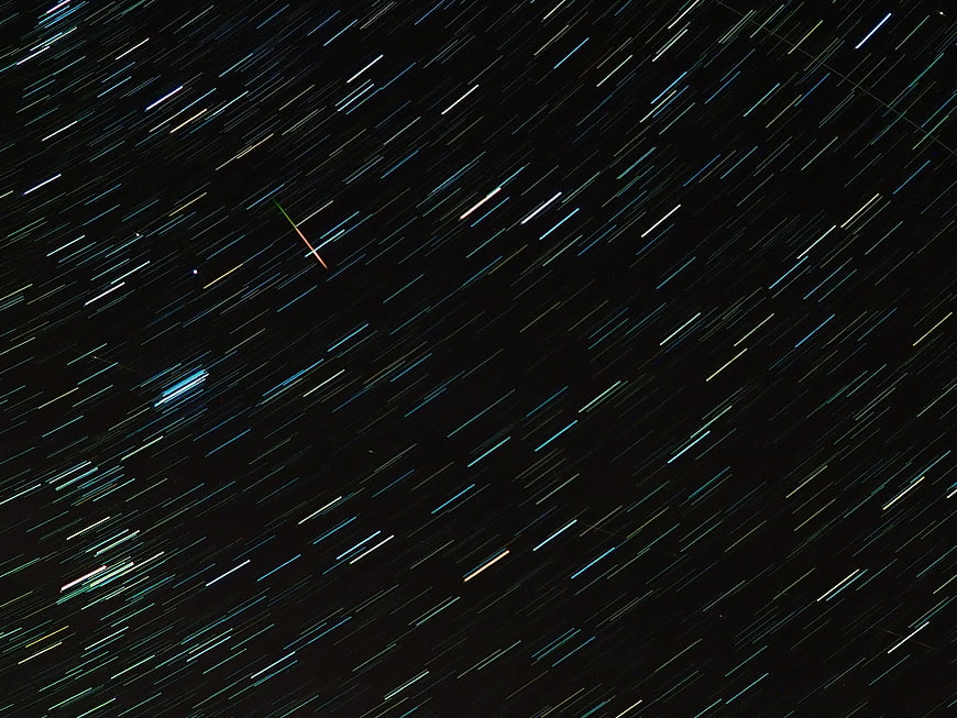 Diagonal Star Trails And Meteor Streaks In Dark Night Sky