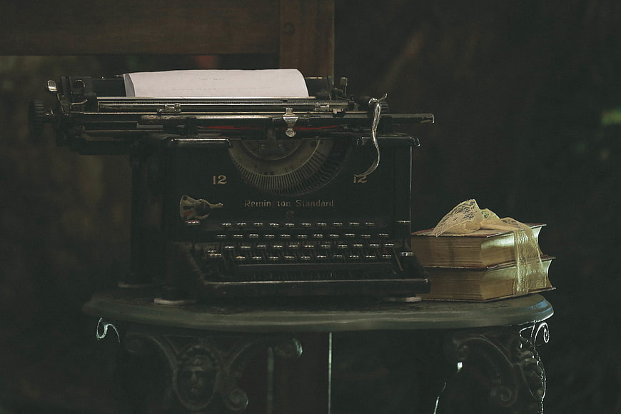 Vintage Remington Typewriter and Old Books on Decorative Table