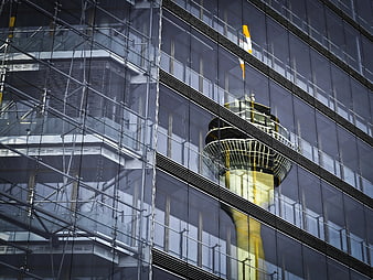 Reflection of Tower in Modern Glass Building Facade