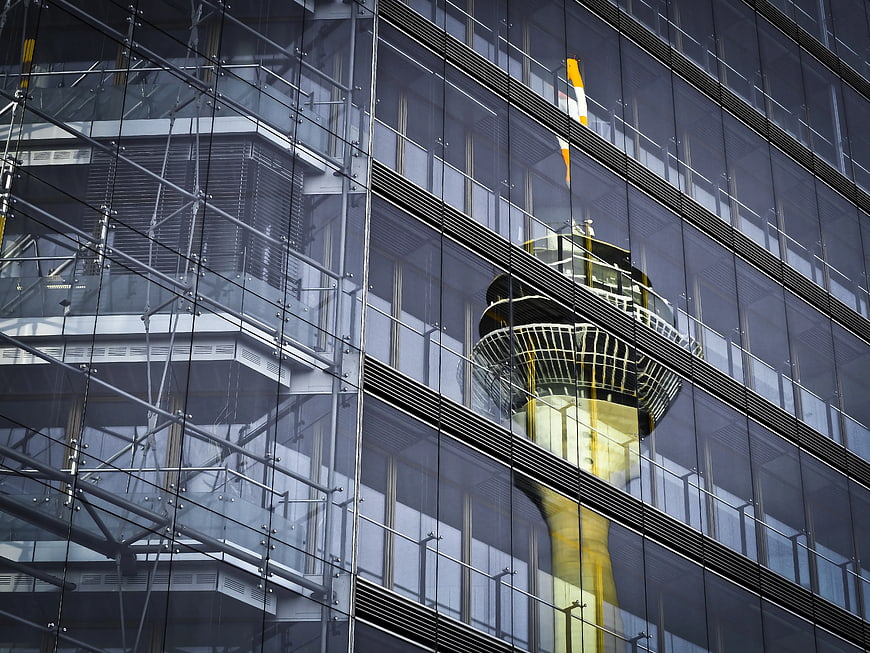 Reflection of Tower in Modern Glass Building Facade
