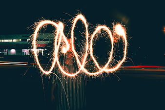 Sparkler light painting infinity symbol at night