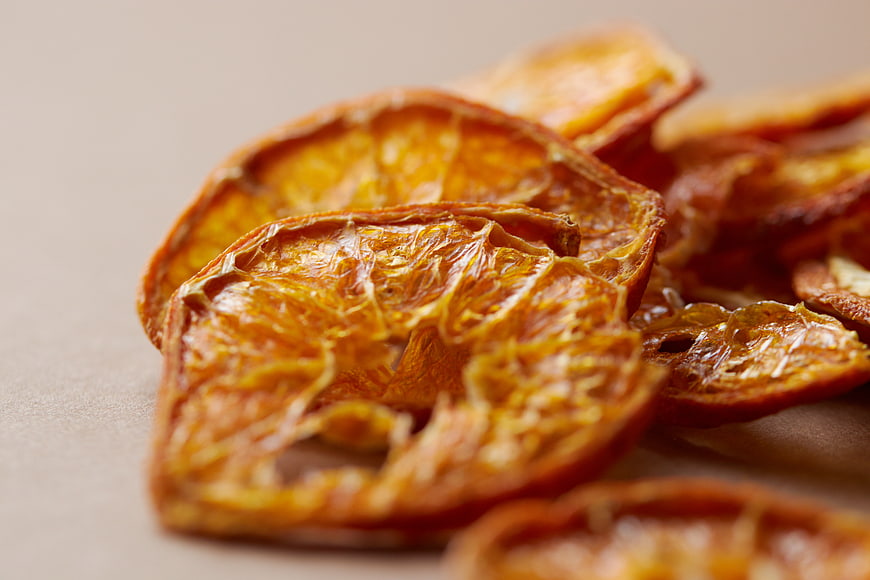 Close-up of dried orange slices on beige background
