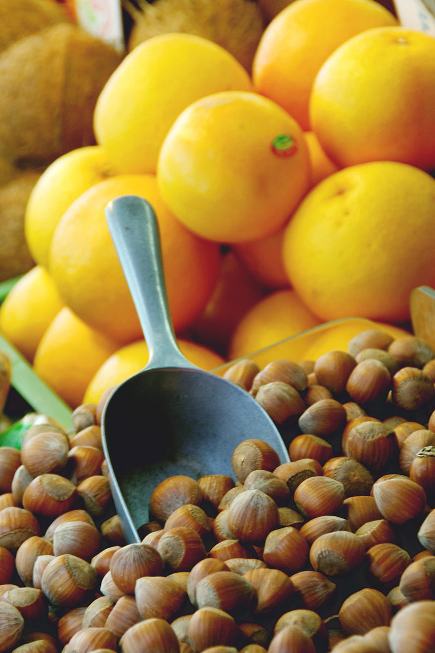 Fresh Hazelnuts and Oranges at a Market Stall