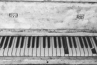 Vintage black and white piano keys with worn texture