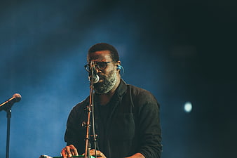 Male Musician Singing and Playing Keyboard on Stage