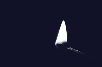 Lit Matchstick Flame Against Dark Blue Background